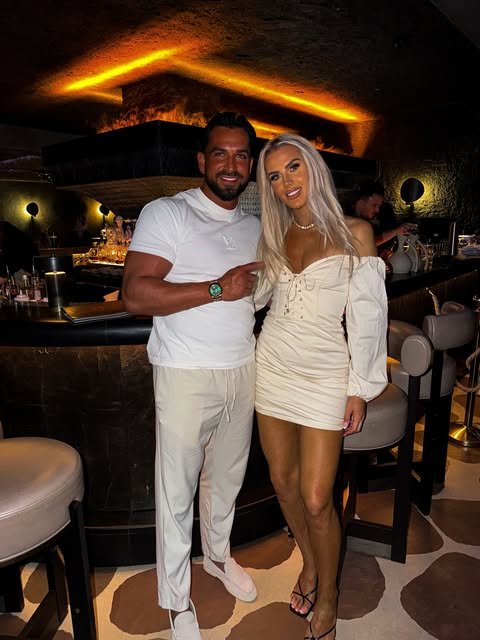 Addam Sattar with a guest at a warmly lit bar