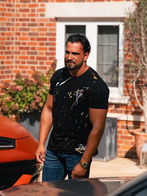 Addam Sattar beside an orange Lamborghini